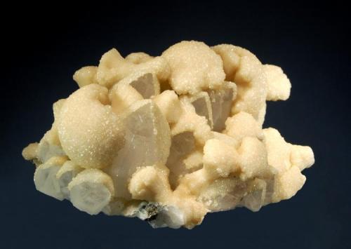 Calcite
Boldut Mine, Cavnic, Maramures, Romania
8.4 x 12.0 cm.
Light tan spherical calcite aggregates partially covering the terminations of  quartz crystals associated with minor pyrite and sphalerite. (Author: crosstimber)