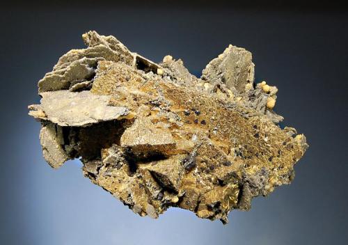 Chalcopyrite
Rodna, Bistrita-Nasaud Co., Romania
6.5 x 9.0 cm.
A large chalcopyrite crystal with flat gray quartz pseudomorphs after pyrrhotite and small black tetrahedrites crystals. (Author: crosstimber)
