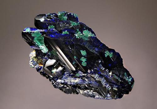 Azurite
Tsumeb Mine, Tsumeb, Namibia
4.5 x 6.7 cm.
Parallel growth of lustrous dark blue azurite crystals partially altered to malachite. (Author: crosstimber)