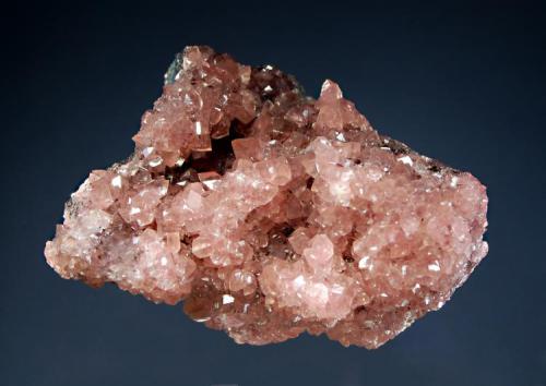 Smithsonite
Tsumeb Mine, Tsumeb, Namibia
6.3 x 8.3 cm.
Small pink rhombs of cobaltian calcite covering a sulfide rich matrix. (Author: crosstimber)