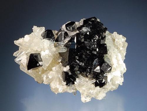 Ilvaite on quartz
Nikolaevskiy Mine, Dal’negorsk, Primorskiy Kray, Russia
4.4 x 5.8 cm.
Doubly terminated ilvaite crystals scattered over a quartz matrix. (Author: crosstimber)