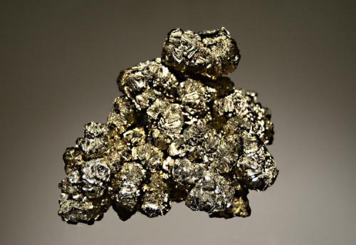 Pyrite
Verchniy Mine, Dal’negorsk, Primorskiy Kray, Russia
5.5 x 8.0 cm.
A floater group of brassy pyrite crystals forming rosettes to 1.5 cm. Difficult to photograph because of the high luster and multitude of crystal faces. (Author: crosstimber)