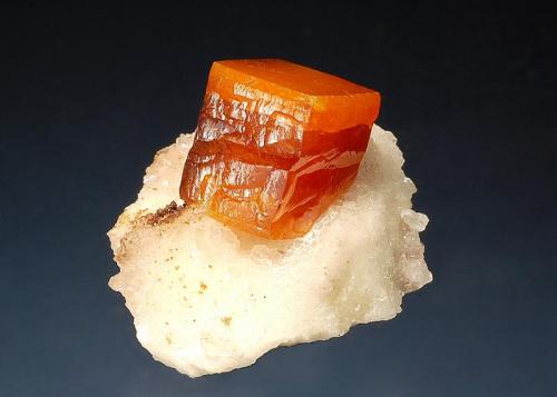 Wulfenite
Erupción Mine, Sierra de Los Lamentos, Chihuauhua, Mexico
2.3 x 2.8 cm.
A bright orange zoned wulfenite crystal on a white calcite matrix. (Author: crosstimber)