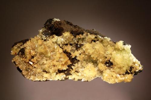 Adamite
Ojuela Mine, Mapimi, Durango, Mexico
7.1 x 13.2 cm.
Lustrous yellow prismatic crystals of adamite with well-defined faces and edges on a brown gossan matrix. (Author: crosstimber)