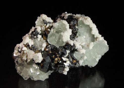 Fluorite
Gibraltar Mine, Naica, Mun. de Saucillo, Chihuahua, Mexico
5.5 x 7.7 cm.
Light green cubic fluorite crystals on lustrous black sphalerite with white calcite, octahedral galena, and brassy yellow pyrite in association. (Author: crosstimber)