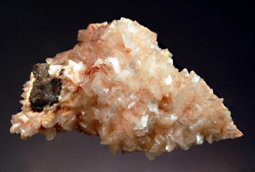 Heulandite
Cape Blomidon, Kings Co., Nova Scotia, Canada
3.8 x 5.7 cm.
Intergrown pearly-lustered pink heulandite crystals on basalt. (Author: crosstimber)