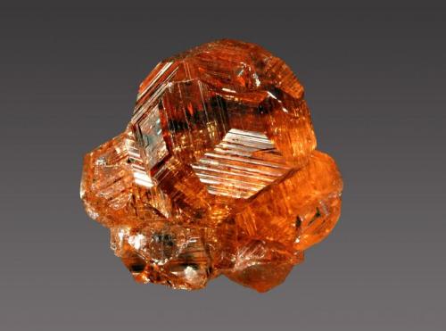 Grossular var. hessonite
Jeffrey Mine, Asbestos, Estrie, Quebec, Canada
1.6 x 1.8 cm.
Gemmy orange grossular var. hessonite with sharp growth patterns on the crystal faces. (Author: crosstimber)
