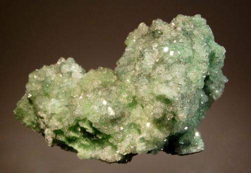 Grossular
Jeffrey Mine, Asbestos, Estrie, Quebec, Canada
4.0 x 6.5 cm.
Gemmy pale green grossular crystals to 2 mm with acicular microcrystals of  green diopside on a mound of white matrix. (Author: crosstimber)