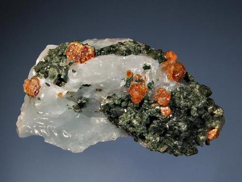 Grossular
York River Skarn, Dungannon Township, Hastings Co., Ontario, Canada
4.1 x 5.5 cm.
Cinnamon brown grossular crystals to 5 mm with green diopside partially etched from colorless calcite. (Author: crosstimber)