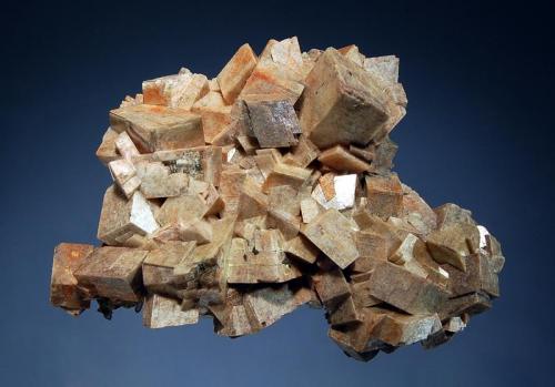 Dolomite
Rabbit Lake Mine, Wollaston Lake, Saskatchewan, Canada
6.5 x 9.0 cm.
An intergrown group of sharp flesh-colored rhombic crystals to 1.7 cm. collected in the early 1980s from the 1240’ bench. (Author: crosstimber)