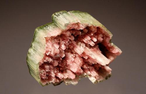 Elbaite
Arqueana Mine, Itinga, Minas Gerais, Brazil
2.3 x 3.2 cm.
Terminal portion of a watermelon tourmaline with a partially dissolved reddish core and a green pinacoid termination. (Author: crosstimber)