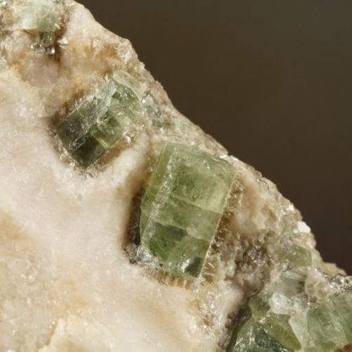 Apatite in calcite with muscovite.
Carrock Mine, Carrock Fell, Caldbeck Fells, Cumbria, UK.
6 mm crystal on 65 mm specimen.
 (Author: Ru Smith)