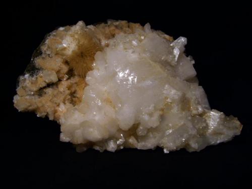 Heulandite
Sgurr nam Boc, Isle of Skye, Scotland, UK
16 cm x 12 cm x 8 cm

The largest heulandite crystal I have collected - it measures 80mm x 50mm. There are smaller heulandite crystals to 25mm and stilbite crystals to 25mm attached to the large crystal, all lustrous, resting on a bed of coloured chabazite crystals to 10mm, and a mesolite spray. The mineral combination appears to be unique to this boulder, near the south end of the beach.
The specimen is repaired - it split in half - right down the middle of the big crystal ! But no way was I going to leave it like that, so I glued the two halves back together. Sorry.
Self-collected 2006 from Sgurr nam Boc. (Author: Mike Wood)