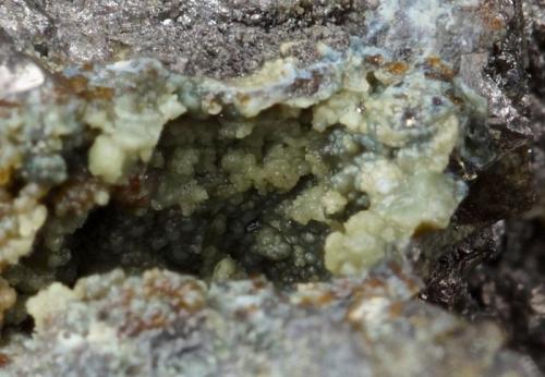 Scorodite with arsenopyrite, pyrite and quartz.
Brandy Gill, Mosedale, Caldbeck Fells, Cumbria, UK.
Field of view 8 mm, 65 mm specimen. (Author: Ru Smith)