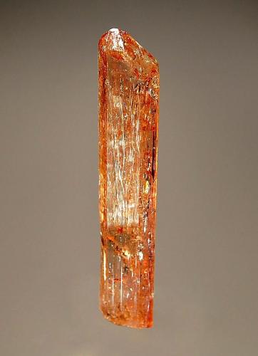 Topaz
Ouro Preto,  Minas Gerais, Brazil
1.5 x 6.4 cm.
A lustrous, golden-brown, transparent prism with a pyramidal termination. (Author: crosstimber)