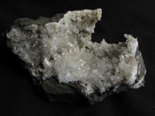 Quartz
Sgurr nan Cearcall, nr Glen Brittle, Isle of Skye, Scotland, UK
14cm x 9cm x 6cm
Large specimen of nice quartz crystals to 12mm or so. There are smaller examples to be seen but this is one of the biggest. I remember spotting this on my first visit in 1997, but didn’t bother with it at the time...Must have been too busy exploring and then forgot about it. Anyway, it was still there 14 years later !
Self-collected 2011 (Author: Mike Wood)