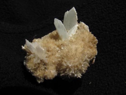 Thomsonite + Apophyllite
Moonen Bay, Isle of Skye, Scotland, UK
26mm x 24mm x 20mm high
’Feathery’ masses of extremely thin thomsonite crystals, somewhat yellowed by dirt or staining. Associated with apophyllite in pyramidal terminated crystals to 7mm.
Self-collected 2002 (Author: Mike Wood)