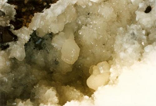 Stilbite
Sgurr nam Boc, Isle of Skye, Scotland, UK
Crystals to approx 5cm
The inside of the cavity (still inside the boulder) showing beautifully fresh stilbite crystals, in a ’wheatsheaf’ type habit.
scanned photo (Author: Mike Wood)