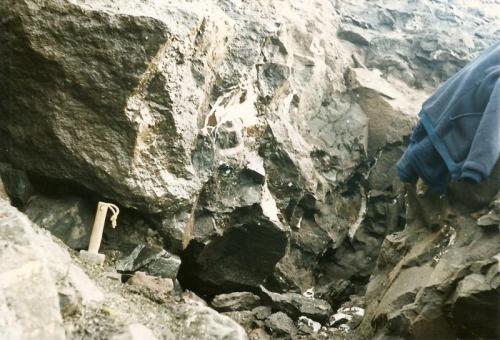 Sgurr nam Boc, Isle of Skye, Scotland, UK
Breaking into a large stilbite cavity with lumphammer and chisels.
Scanned photo (Author: Mike Wood)
