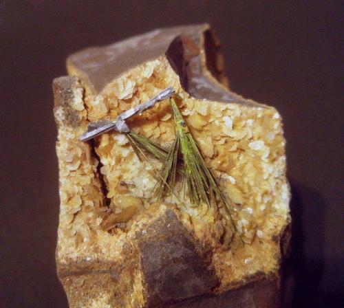Millerite
Deep Navitation Colliery, Treharris, Merthyr Tydfil, Wales, UK
longest crystal 27mm
Greenish, oxydised millerite sprays, with one crystal totally covered with elongated galena crystals, on siderite within an ironstone cavity. Siegenite crystal, 0.5mm to the left of the millerite. collected August 1995. (Author: ian jones)