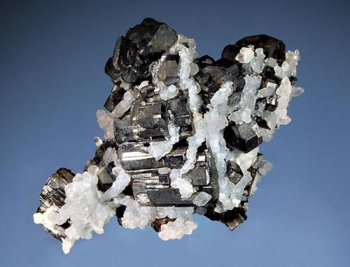 Bournonite
Pachapaqui District, Bolognesi Prov., Ancash Dept. Peru
5.2 x 6.8 cm
Classic cogwheel-shaped crystals of metallic black bournonite partially overgrown with colorless quartz crystals. (Author: crosstimber)
