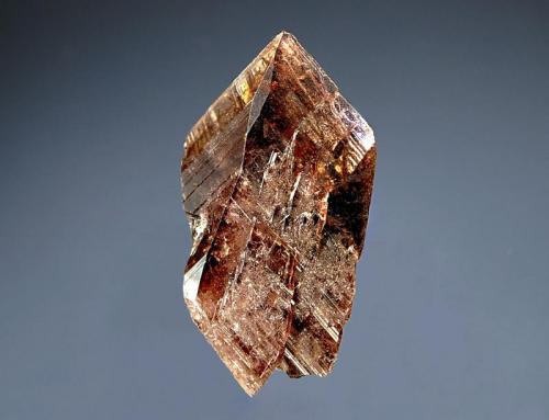 Axinite
Molletambo, near Espinal, Ica Dept., Peru
2.0 x 3.3 cm.
A sharp, bladed, root-beer colored axinite crystal. (Author: crosstimber)