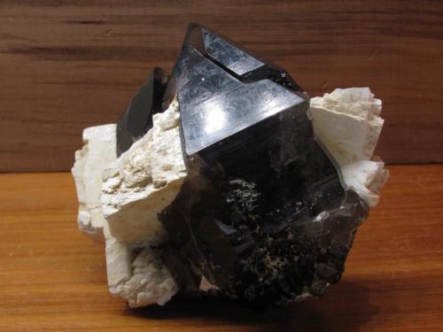 Smoky Quartz + Microcline
Isle of Arran, Scotland, UK
8cm x 7cm high x 4cm
Double-terminated quartz crystal 72mm long, fairly clear near the top. The feldspar crystals are sadly damaged. Self-collected. (Author: Mike Wood)