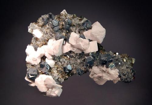 Galena
Pachapaqui District, Bolognesi Province, Ancash Department, Peru
7.4 x 9.4 cm.
Lead gray, cuboctahedral galena crystals associated with pale pink calcite rhombs, cubic pyrite, quartz, and sphalerite. (Author: crosstimber)