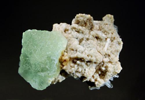 Fluorite
Huanzala Mine, Huallanca District, Dos de Mayo Province, Huanuco Dept., Peru
5.5 x 7.0 cm.
Pale green octahedral fluorite crystal measuring 4.0 cm on a matrix of cream to tan dolomite and quartz crystals. (Author: crosstimber)