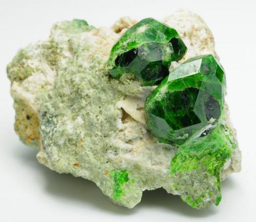 Andradite (var: Demantoid)
Belqeys Mountain (Kuh-e-Belgheys), Takab, West Azarbaijan Province, Iran
Larger crystal is 1.6 cm. The specimen is 5 cm in length.
A gorgeous and impressive specimen of lustrous bright/dark green demantoid garnet from a new find. (Author: vhairap)
