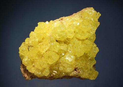 Sulfur
El Desierto Mine, San Pablo de Napa, Daniel Campos Prov., Potosi Dept., Bolivia
6.4 x 8.4 cm.
Gemmy, complex sulfur crystals on a gray altered volcanic matrix. (Author: crosstimber)