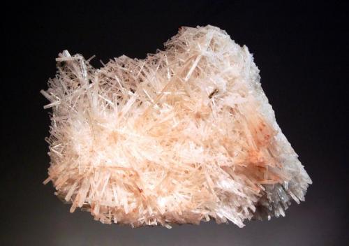 Natrolite
San Agustin Del Valle Fertil, San Juan Prov., Argentina
4.6 x 7.6 x 10.2 cm.
Colorless acicular crystals of natrolite to 3.5 cm with reddish-brown iron oxide inclusions. Collected in Summer 2004. (Author: crosstimber)