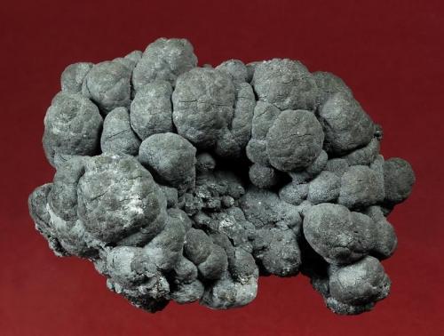 Chalcocite
Flambeau Mine, near Ladysmith, Rusk County, Wisconsin, USA
61 x 46 x 43 mm

Gunmetal grey, knobby spheroids of Chalcocite to 14 mm make up this unusual specimen from the Flambeau Mine. The identification was confirmed by analysis done by Casey Jones, who collected it. It perfect condition. (Author: GneissWare)