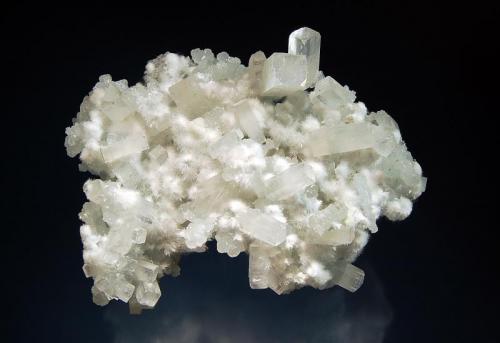 Apophyllite-(KF)
Kandivali Quarry, Malad, Ward 38, Mumbai District, Maharashtra, India
7.5 x 9.5 cm.
Colorless elongated pseudocubic crystals of apophyllite on pale green prehnite associated with snow white spheres of acicular okenite. (Author: crosstimber)