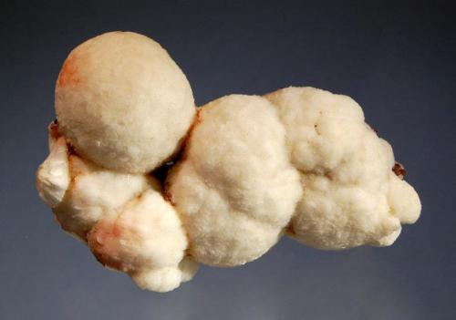 Thomsonite
Soygaon, Aurangabad District, Maharashtra, India
4.5 x 7.6 cm.
A group of creamy white thomsonite spheres with reddish-brown iron oxide tinges. (Author: crosstimber)