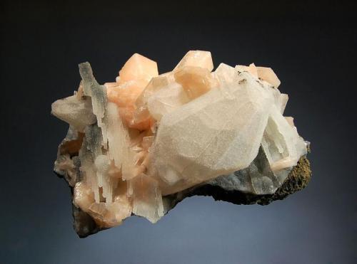 Quartz ps. calcite
Jalgaon District, Maharashtra, India
7.5 x 9.9 cm.
Colorless quartz epimorphing calcite associated with stalactitic chalcedony and peach-colored stilbite crystals. (Author: crosstimber)