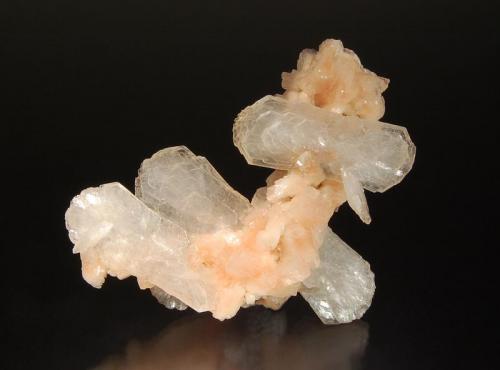 Stilbite-(Ca)
Chalsigaon, Jalgaon District, Maharashtra, India
6.6 x 6.8 cm.
Bladed, colorless stilbite crystals to 4.0 cm on a stalactite of small peach-colored heulandite crystals. (Author: crosstimber)