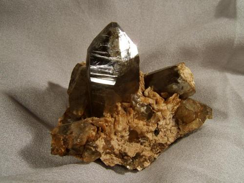 Smoky Quartz + Albite
Lundy Island, Devon, England, UK
80mm x 55mm x 65mm high (specimen)
Nicely terminated smoky quartz crystal 40mm tall on pegmatite matrix. Collected 1998. (Author: Mike Wood)