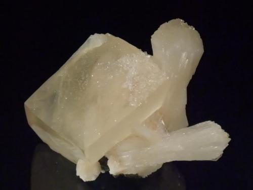 Calcite with Stilbite
Lonavala, India
7x5cm
A complete calcite rhomb of a very soft yellow colour 4cm on edge, sprinkled with tiny apophyllite crystals. Stilbite crystals to 4.5cm and bright green apophyllite to 5mm on the back. (Author: Greg Lilly)