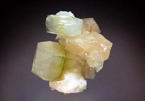 Apophyllite-(KF)
Nasik District, Maharashtra, India
5.0 x 6.4 cm.
Blocky crystals of apophyllite-(KF) with a distinct green band in the middle of the prism and truncated corners associated with peach-colored stilbite and white chalcedony. (Author: crosstimber)
