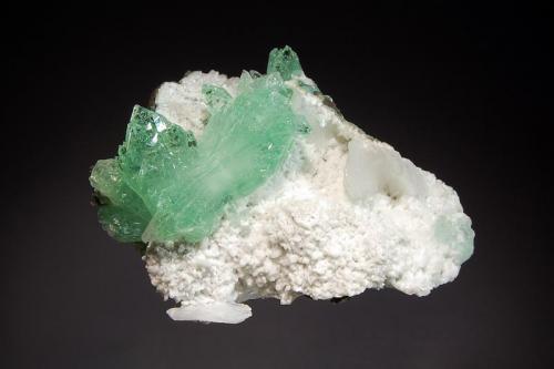 Apophyllite-(KF)
Pashan #2 Quarry, Pune, Maharashtra, India
5.8 x 7.2 cm.
Gemmy mint green fluorapophyllite crystals on a white stilbite covered basalt matrix. (Author: crosstimber)