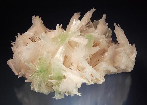 Scolecite
Rahuri, Ahmednagar District, Maharashtra, India
9.0 x 13.0 cm.
A jackstraw arrangement of pale pink scolecite crystals with light green crystals of apophyllite-(KF). This specimen was collected during a well dig in 2004, and according to the dealer there was only one pocket that contained these pink scolecites. (Author: crosstimber)