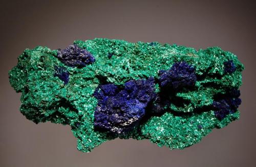 Azurite and Malachite
Bou Bekker, Touissit, Oujda-Angad Province, Oriental Region, Morocco
5.0 x 10.6 cm.
Dark blue crystallized azurite associated with almost fibrous green malachite. (Author: crosstimber)