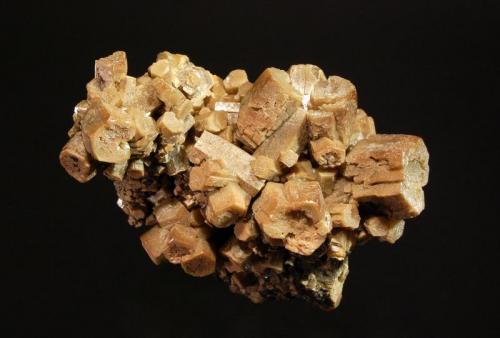 Vanadinite var. arsenian
Zelidja Mine, Touissit, Oujda-Angad Province, Oriental Region, Morocco
4.5 x 7.5 cm.
Barrel-shaped vanadinite crystals with slightly hoppered pinacoid terminations. (Author: crosstimber)