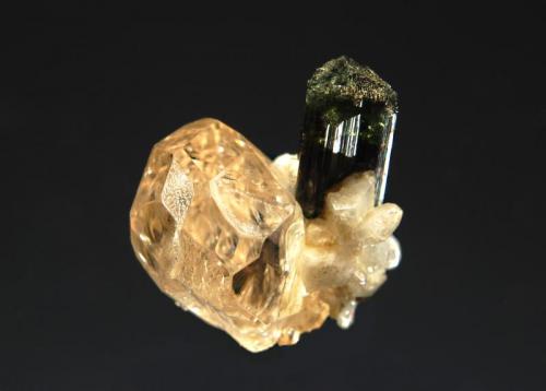 Topaz
Chamachhu, Haramosh Mts., Skardu District, Baltistan, Gilgit-Baltistan, Pakistan
1.8 x 2.3 cm.
Terrible photo of a sherry-colored topaz with albite and elbaite. (Author: crosstimber)