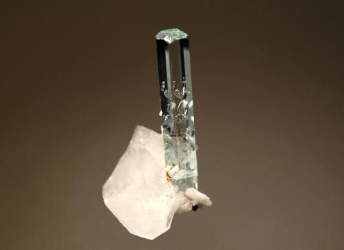 Beryl var. aquamarine
Saichis, near Balachi, Gilgit-Baltistan, Pakistan
2.7 x 5.0 cm.
A pale blue transparent aquamarine crystal attached to a small quartz crystal with minor albite. (Author: crosstimber)
