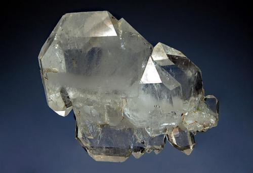 Quartz
Tole, South Waziristan, FATA, Pakistan
5.1 x 7.0 cm
Glassy, transparent, tabular quartz crystals in parallel growth with a prominent milky faden line visible roughly perpendicular to the c-axis. (Author: crosstimber)