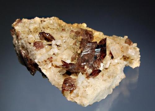 Axinite
Khapalu, Ghanche District, Gilgit-Baltistan, Pakistan
7.1 x 8.8 cm.
A triangular plate of feldspar hosting sharp gemmy brown axinite crystals with small crystals of adularia. (Author: crosstimber)