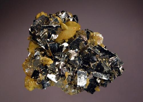 Arsenopyrite
Dachang ore field, Nandan Co., Guangxi Zhuang Prov., China
5.6 x 6.3 cm.
Silvery, metallic, wedge-shaped arsenopyrite crystals associated with flattened tan rhombs of siderite. (Author: crosstimber)