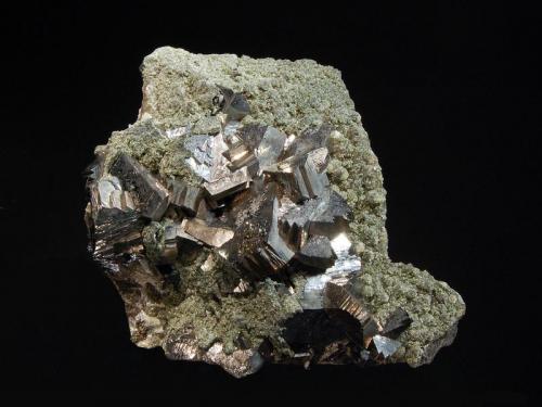 Arsenopyrite
Yaogangxian Mine, Yizhang Co., Chenzhou Pref., Hunan Province, China
6.0 x 8.2 cm.
Silvery metallic arsenopyrite crystals to 1.5 cm scattered on a breccia matrix coated with pale olive-green micro crystals of what may be chamosite. (Author: crosstimber)